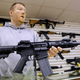 John Jackson, co-owner of Capitol City Arms Supply shows off an AR-15 assault rifle for sale Wednesday, Jan. 16, 2013 at his business in Springfield, Ill.